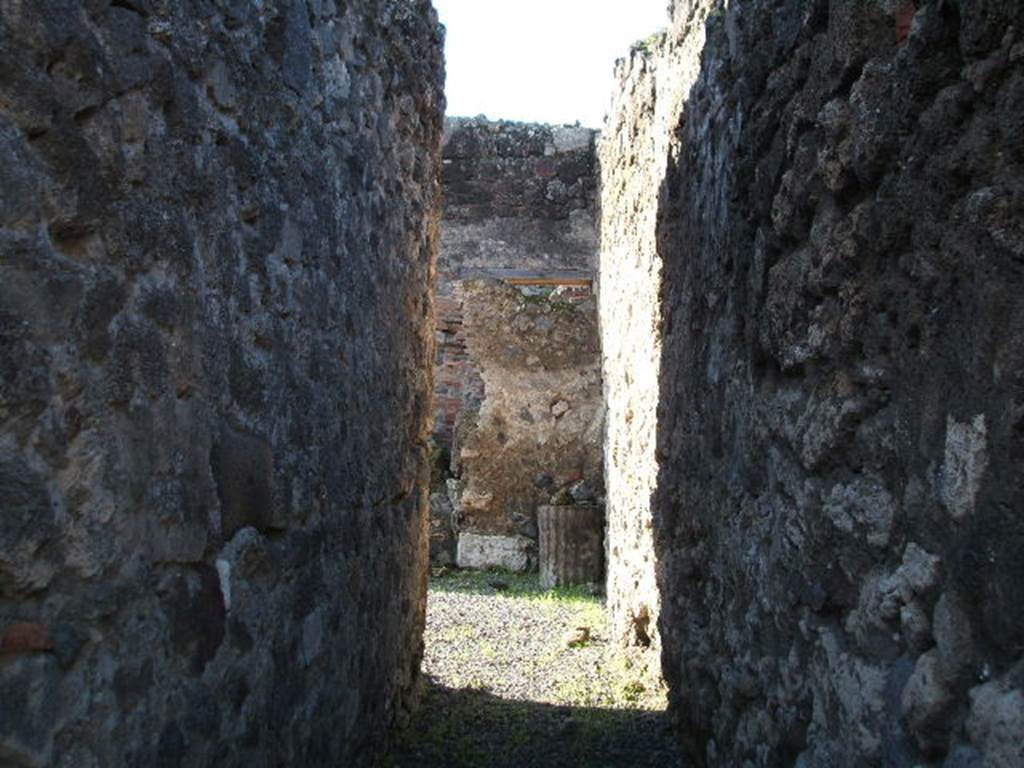 VII.1.30 Pompeii. December 2004. Looking west along long entrance corridor. According to Fiorelli, a corridor led from the street to a stable, which was partly covered with a roof, and had a long podium for use as a manger.