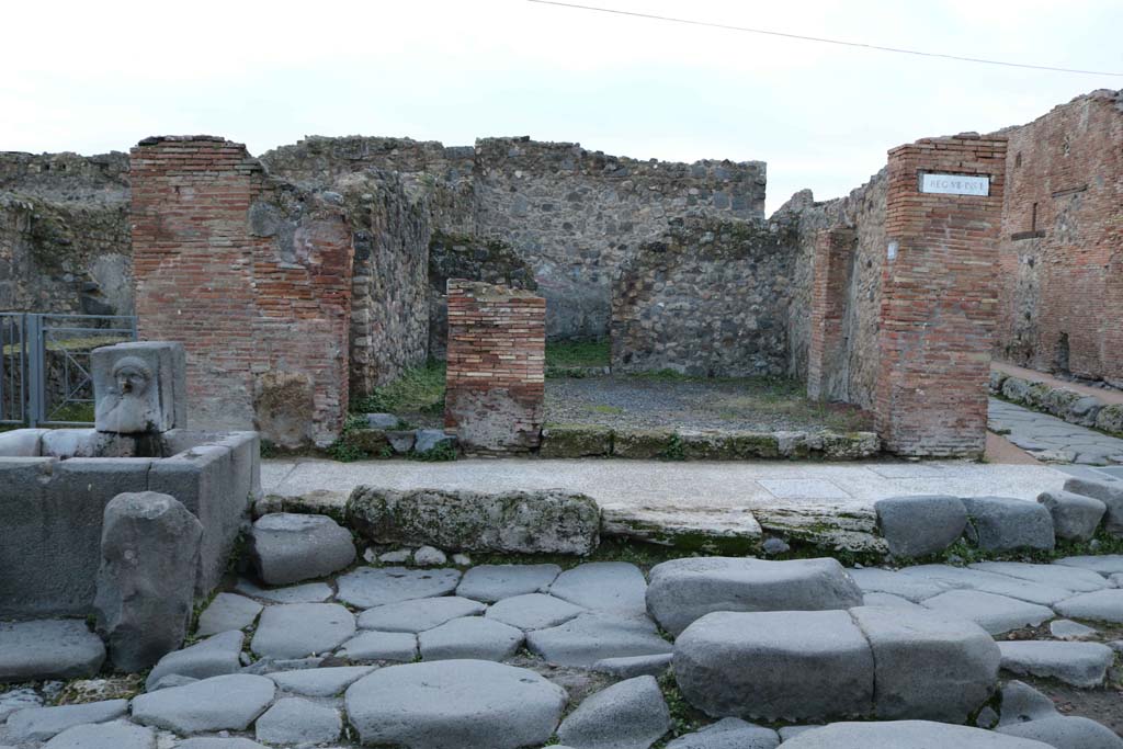 VII.1.33 Pompeii, on right of fountain, and VII.1.34 Pompeii, centre right. December 2018.
Looking west towards entrance doorways. Photo courtesy of Aude Durand.