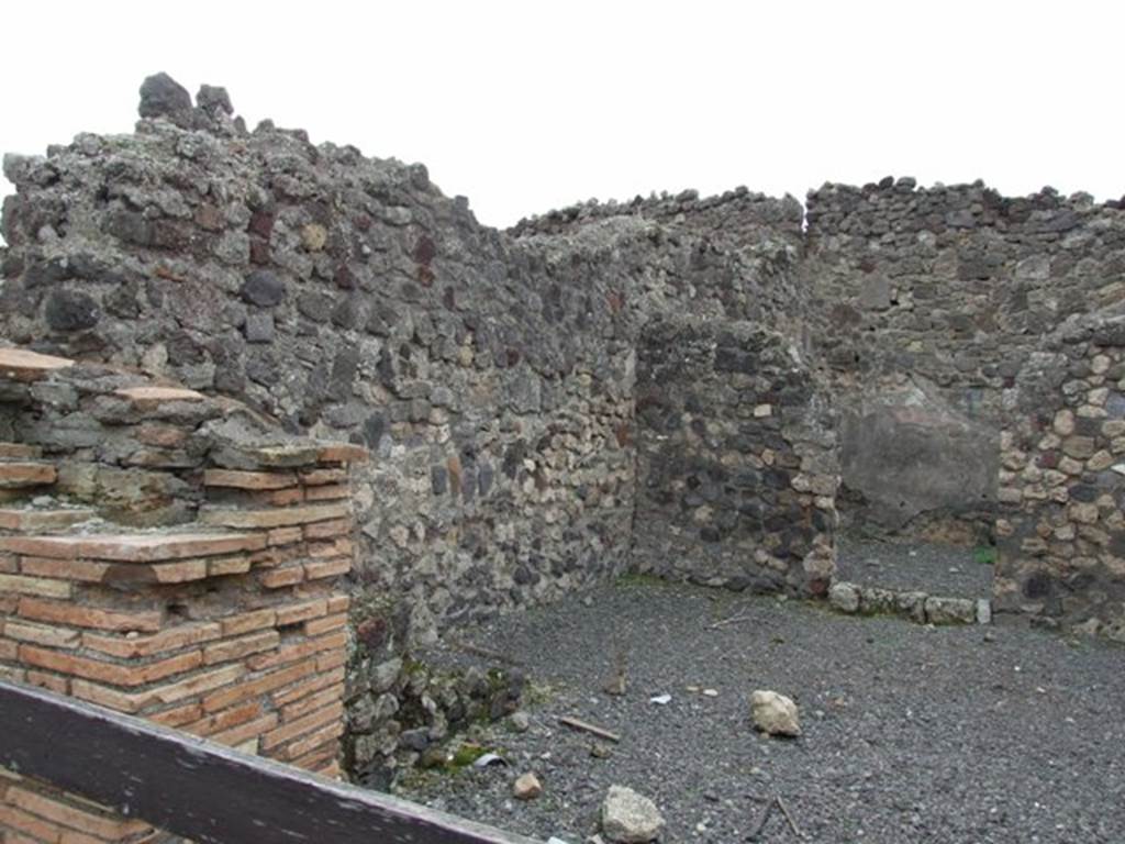 VII.1.34 Pompeii. December 2007. Entrance pillar of shop on the south side.
Remains of stairs of VII.1.33 are to the left front next to the south wall of the shop.