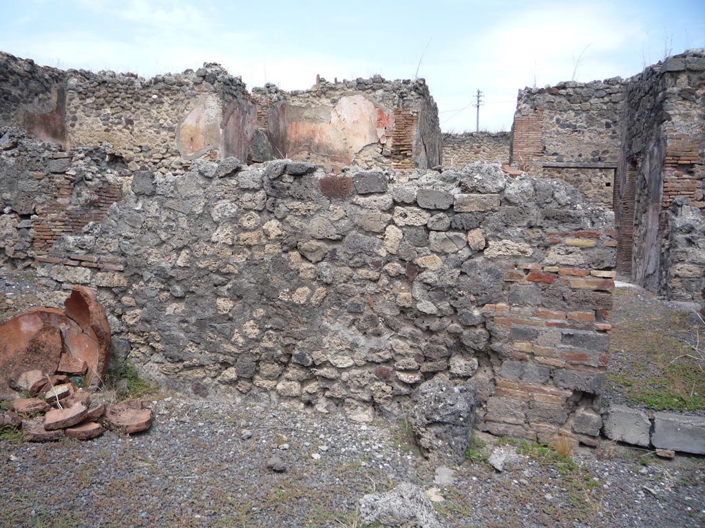 VII.1.36 Pompeii. October 2009.
Looking north to south wall of atrium, with doorway to south-east corner, on right. Photo courtesy of Jared Benton.