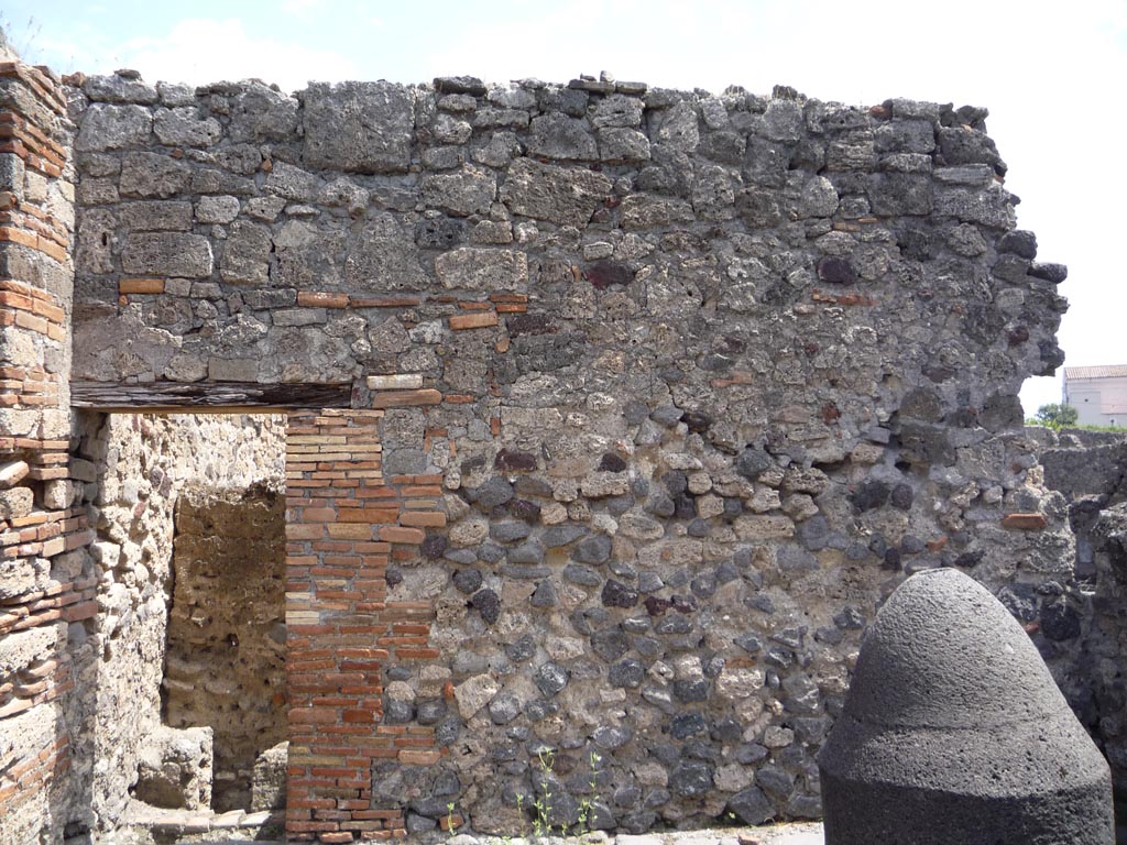 VII.1.36 Pompeii. October 2009.
East wall of room in south-east corner, with doorway to latrine, on left. Photo courtesy of Jared Benton.