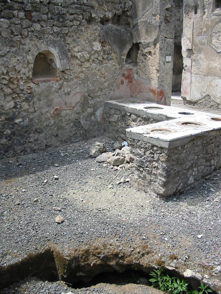 VII.1.39 Pompeii. May 2003.
Looking north-west across counter, with niche in west wall. Photo courtesy of Nicolas Monteix.