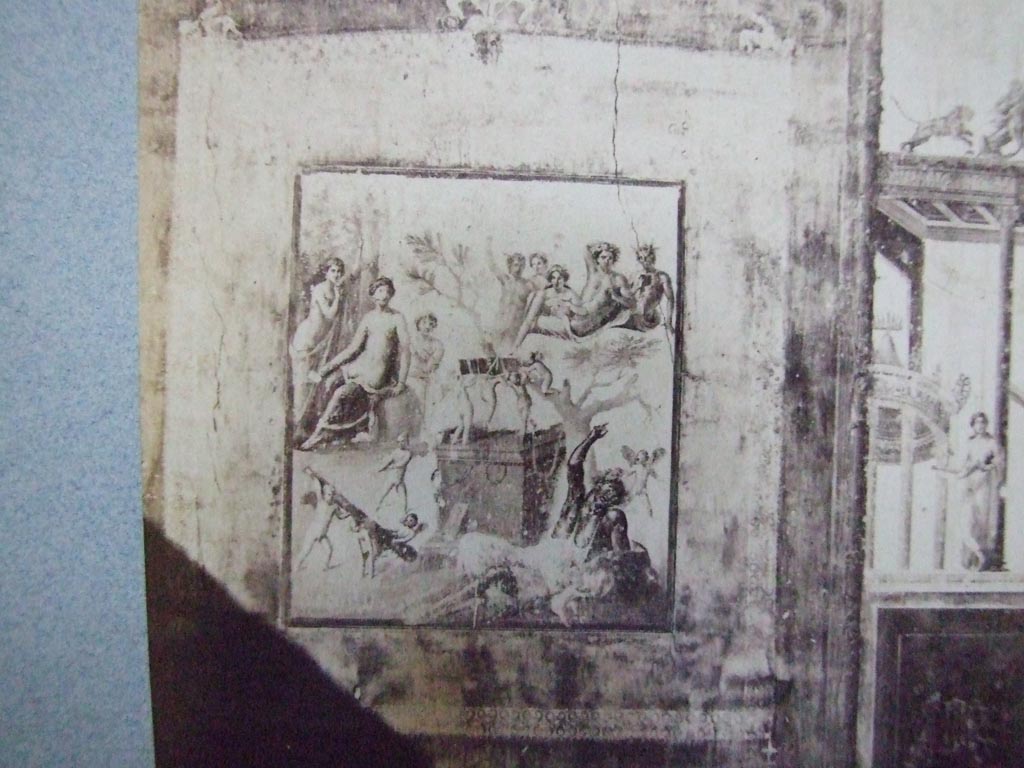 VII.1.47 Pompeii. Photo c. 1860s? Exedra in north-west corner of atrium.
Detail of wall painting of the Drunken Hercules.
Hercules, inebriated, is lying on the ground at the foot of a cypress tree.
On the altar, three Cupids, bear on their shoulders the hero's quiver.
Four other Cupids are on the ground playing with his club.
On the left a group of three females round a column with a vase on top.
The central figure, Omphale(?), seems to look with interest on the drunken hero.
On the right, half way up a mountain, sits Bacchus, surrounded by his attendants.
See Pompeii Its History Buildings and Antiquities by Thomas Dyer, pages 463 to 465.
Old undated photograph. Courtesy of Society of Antiquaries, Fox Collection.