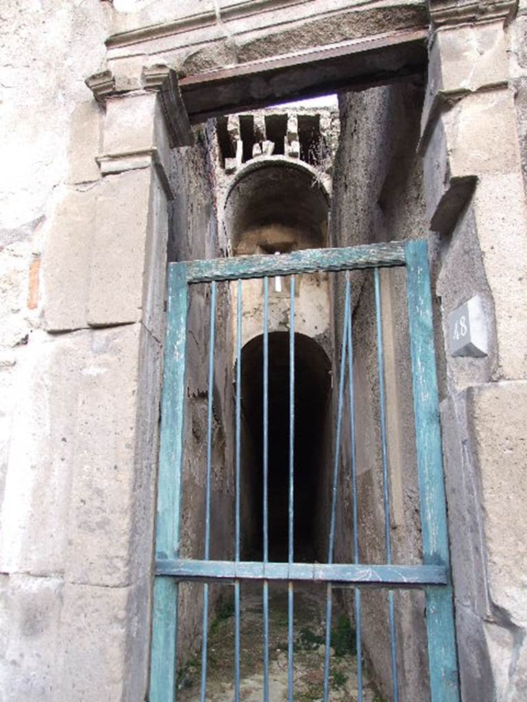 VII.1.48 Pompeii. December 2006. Looking east through small doorway of Stabian Baths along corridor K.