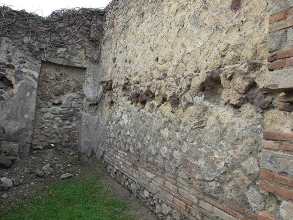 VII.2.13 Pompeii. Shop with dwelling. December 2007. North wall, with walled up door to atrium of VII.2.14 in north west corner.