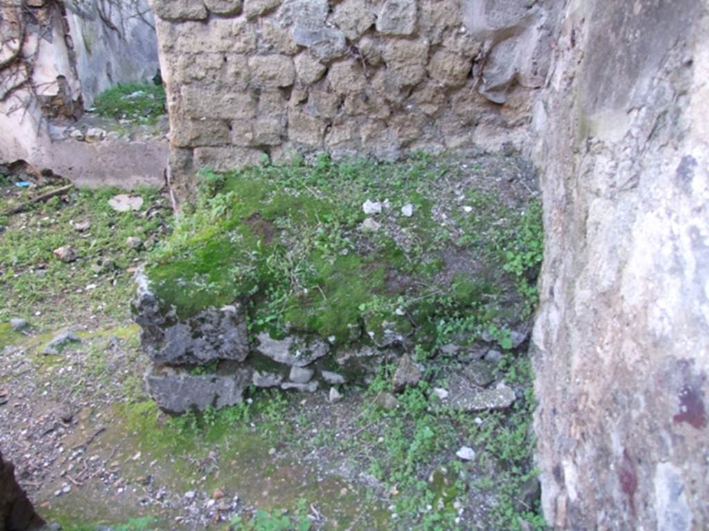 VII.2.14 Pompeii. March 2009. Masonry bench or hearth against south wall of kitchen. According to Boyce, in the west wall of the kitchen is an arched niche called in the report “una nicchia per I lari”. See Boyce G. K., 1937. Corpus of the Lararia of Pompeii. Rome: MAAR 14. (250, p. 62)