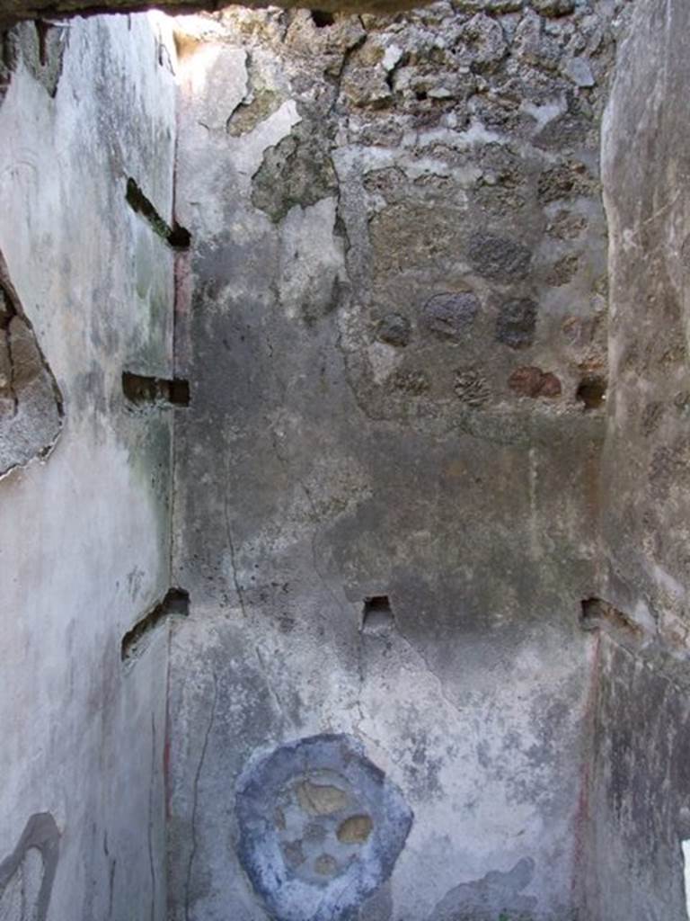 VII.2.18 Pompeii. March 2009. Room 15, east wall with holes for shelving supports.