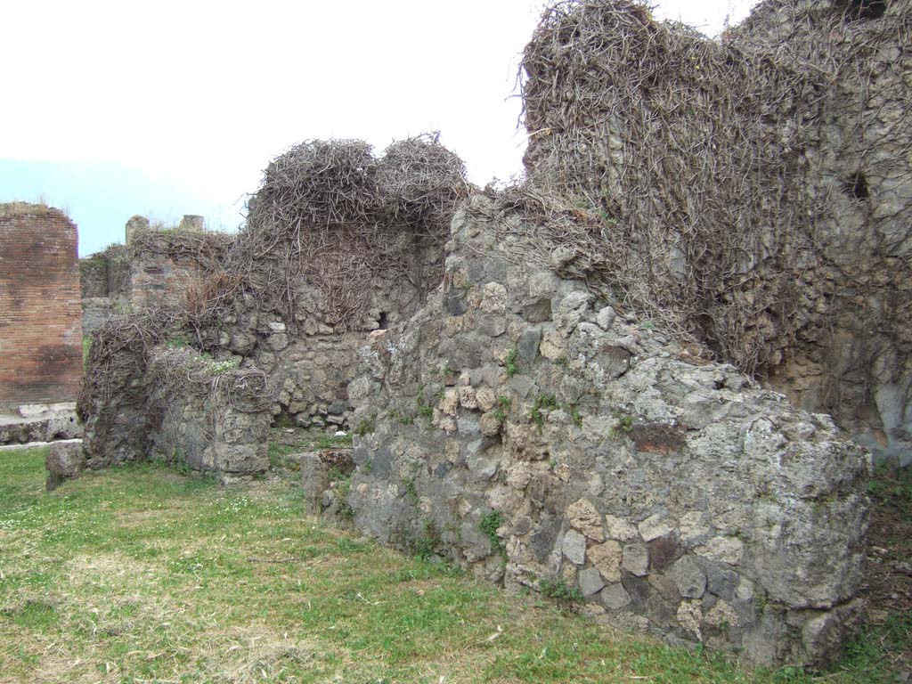 VII.2.38 Pompeii. May 2006. West side of atrium, doorway to shop (on left) and doorways to two cubicula.
