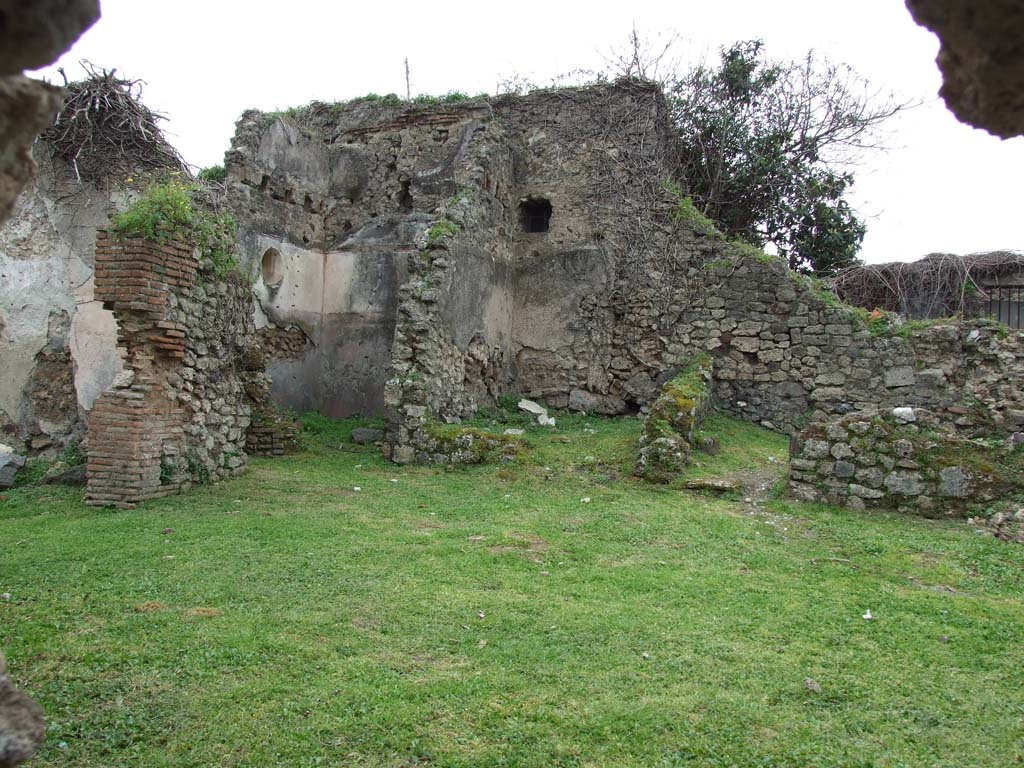 VII.3.13 Pompeii. March 2009. Looking south-west across garden area.
South side. Large triclinium and passage to kitchen & latrine.
West side of garden area. Doorways to two cubicula & passage room, leading to VII.3.11