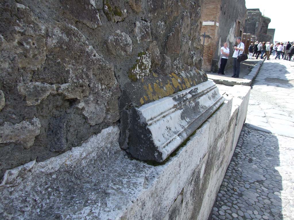 VII.4.1 Pompeii. March 2009. Marble cornice on north wall above pavement on Via della Fortuna. Looking west.
According to Niccolini in 1854, the pavement was unique in that it came from the ancient works of crushed and well-polished gravel
See Niccolini F, 1854. Le case ed i monumenti di Pompei: Volume Primo. Napoli, Tempio della Fortuna, Tav. I, n. 13, p. 4.