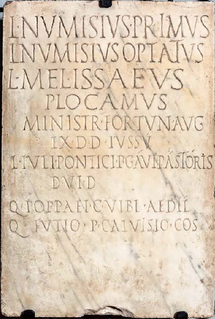 VII.4.1 Pompeii. Dedicatory inscription to Lucius Numisius Primus, Lucius Numisius Optatus, Lucius Melissaeus Plocamus, ministry of Fortuna Augusta.
According to Epigraphik-Datenbank Clauss/Slaby (See www.manfredclauss.de) this read

Lucius Numisius Primus, Lucius Numisius Optatus, Lucius Melissaeus Plocamus, attendants of Augustan Fortune; in accordance with a decree of the town councillors, by command of Lucius Iulius Ponticus and Publius Gavius Pastor, duumvirs with judicial power, and of Quintus Poppaeus and Gaius Vibius, aediles, in the consulship of Quintus Futius and Publius Calvisius. (CIL X 827 = ILS 6384)
See Cooley, A. and M.G.L., 2014. Pompeii and Herculaneum: A Sourcebook. London: Routledge, p. 136, E50.

According to Epigraphik-Datenbank Clauss/Slaby (See www.manfredclauss.de) this read

L(ucius) Numisius Primus
L(ucius) Numisius Optatus
L(ucius) Melissaeus
Plocamus
ministr(i) Fortun(ae) Aug(ustae)
ex d(ecreto) d(ecurionum) iussu
L(uci) Iuli Pontici P(ubli) Gavi Pastoris
d(uum)v(irorum) i(ure) d(icundo)
Q(uinti) Poppaei C(ai) Vibi aedil(ium)
Q(uinto) Futio P(ublio) Calvisio co(n)s(ulibus)      [CIL X 827]

Now in Naples Archaeological Museum. Inventory number 3771.
