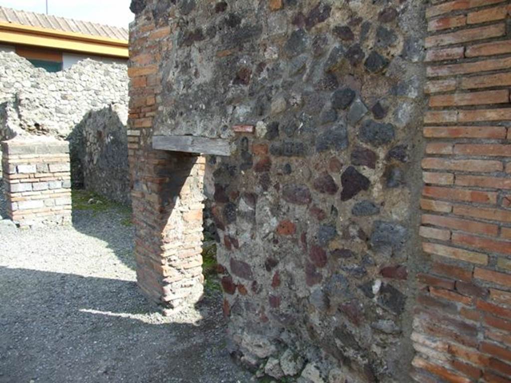 VII.4.4 Pompeii. March 2009. South wall of thermopolium, with doorway to cupboard or small room, under stairs of entrance VII.4.5