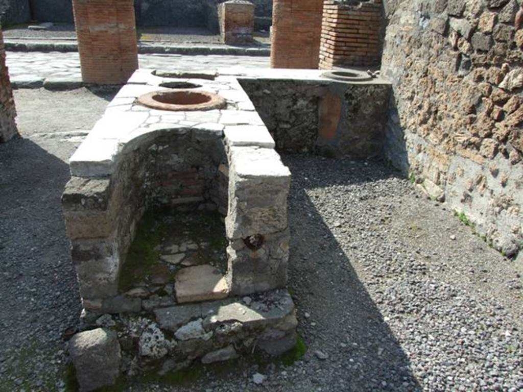 VII.4.4 Pompeii. March 2009. Looking west towards Via del Foro, from rear of counter with hearth on its eastern end.