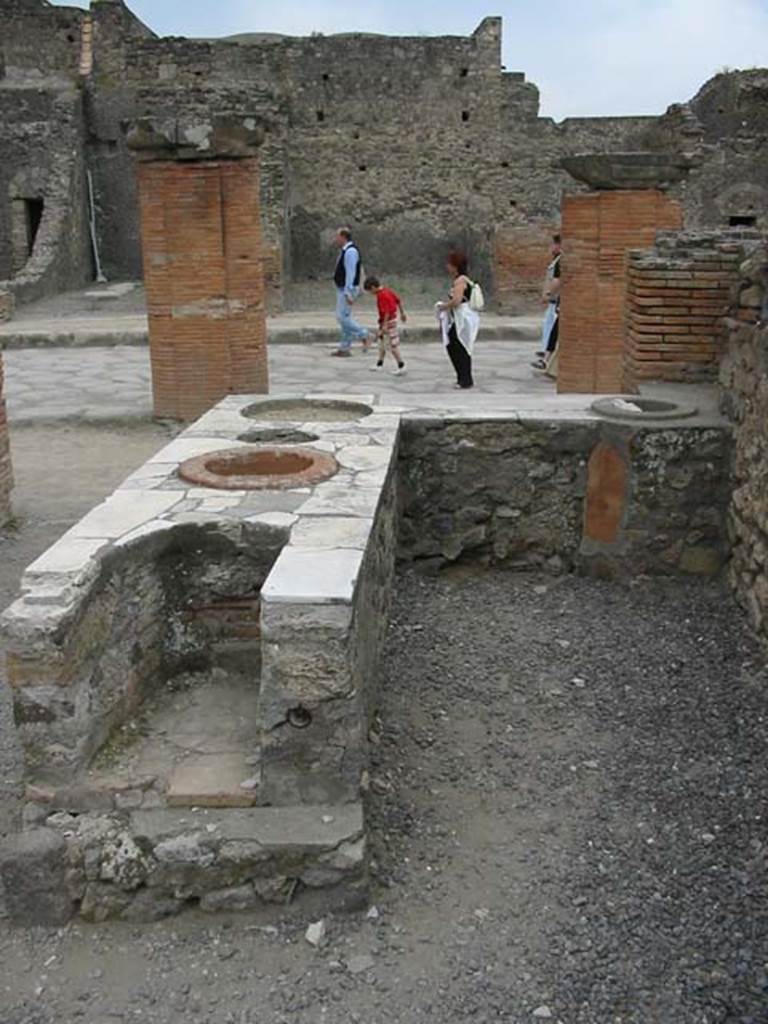 VII.4.4 Pompeii. May 2003. Looking west towards Via del Foro, from rear of counter with hearth on its eastern end. Photo courtesy of Nicolas Monteix.