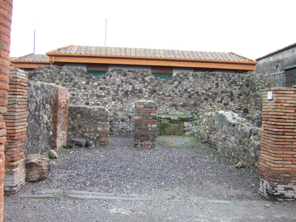 VII.4.6 Pompeii. December 2005. Looking east across shop to doorway to rear room.
Found in September 1823, painted in red on the pilaster between VII.4.5 and 6, on the left, was –

Fausto  […]  II vir 
[……]
M(arcum)  Nollium  et  M(arcum)
Calventium       [CIL IV 518]

See Pagano, M. and Prisciandaro, R., 2006. Studio sulle provenienze degli oggetti rinvenuti negli scavi borbonici del regno di Napoli. Naples: Nicola Longobardi. (p. 127)

