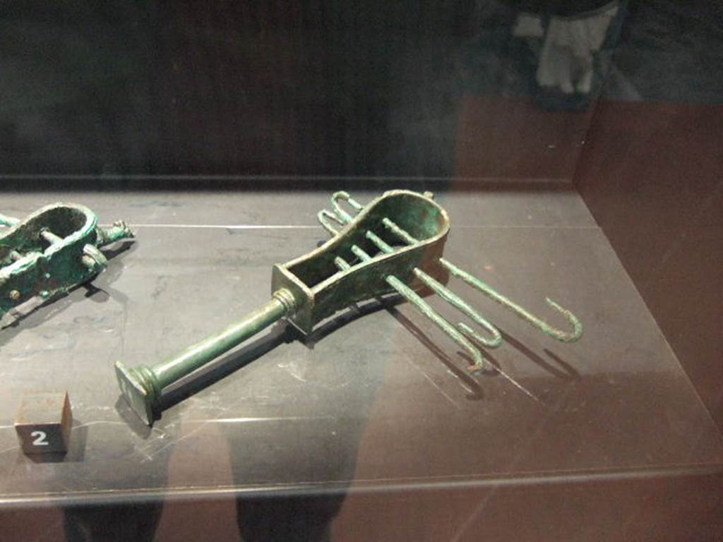 Bronze Sistrum found in VII.4.13. Now in Naples Archaeological Museum.