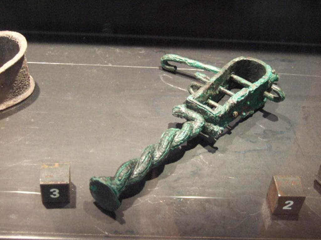 Bronze Sistrum found in VII.4.13. Now in Naples Archaeological Museum.