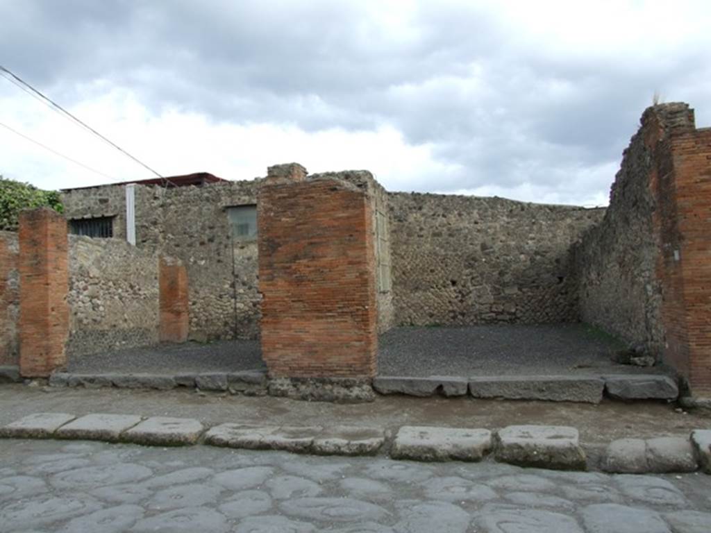 VII.4.13 and VII.4.14 December 2007. Looking east across Via del Foro.
Note how low the pavement is against the sills of the shops, as opposed to the picture below.
