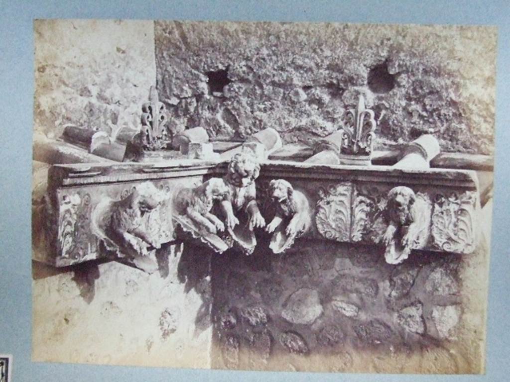 “Cornice in terracotta of a Compluvium preserved at Pompeii”.
Old photograph courtesy of Society of Antiquaries, Fox Collection.
These are Grondaia or rainwater spouts that fed rainwater from the Compluvium in the roof to the Impluvium below. These were reconstructed and displayed during the 19th century in VII.4.15/16 before the Antiquarium was opened. Mau says they were originally from a House near the Porta Marina, The plan provided by Mau can be used to identify the house as VII.16.12/15 the House of Umbricius Scaurus. See Mau, A., 1907, translated by Kelsey F. W. Pompeii: Its Life and Art. New York: Macmillan. (p.251, p.253, p.298).