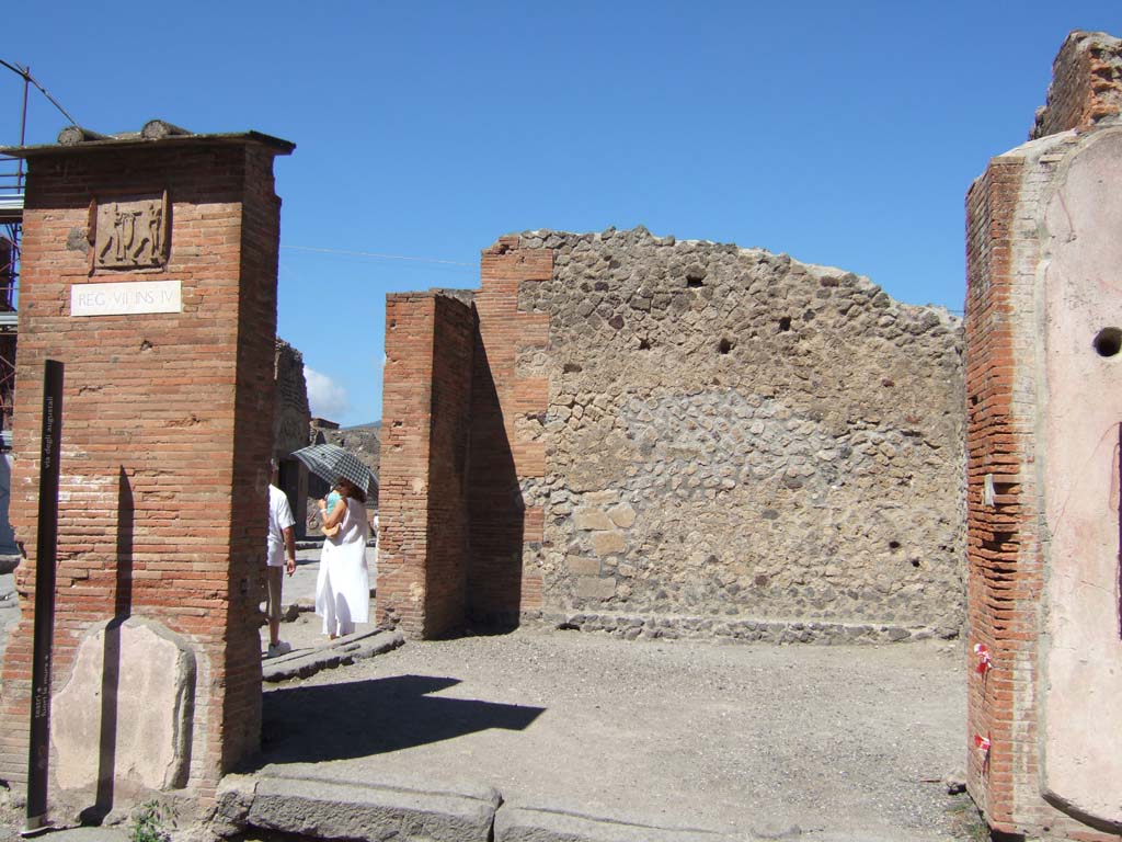 VII.4.16 Pompeii. September 2005. Caupona. On the left pillar was a picture of Mars now destroyed.
According to Boyce, the picture was of a youthful male figure in tunic and pallium probably Mars, holding a shield in his left hand, and a spear in his right hand.
See Boyce G. K., 1937. Corpus of the Lararia of Pompeii. Rome: MAAR 14. (p.111, no.14, and Helbig 22)
On the right pillar is a street altar with a picture of Jupiter, see VII.4.17.
See Fröhlich, T., 1991, Lararien und Fassadenbilder in den Vesuvstädten. Mainz: von Zabern. (F48: p.325).
See Eschebach, L., 1993, Gebäudeverzeichnis und Stadtplan der antiken Stadt Pompeji. Köln: Böhlau. (p.275).