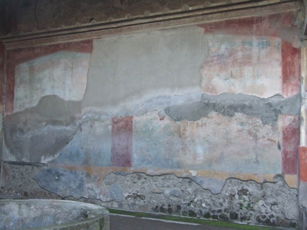 VII.4.48 Pompeii. December 2007. Peristyle, west wall. Due to the explosion of a bomb which fell in 1943, the west wall suffered from the destruction and the partial fall of the plaster from the large painting. The figure of Galatea in the centre of the lower zone was definitely destroyed.
See Garcia y Garcia, L., 2006. Danni di guerra a Pompei. Rome: L�Erma di Bretschneider. (p.98, fig 218)
