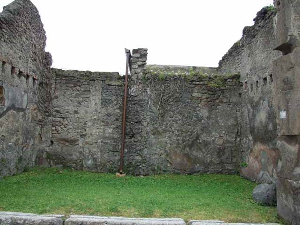 VII.4.49 Pompeii. May 2010. South wall with a bricked-up doorway to a rear room in the south-west corner.