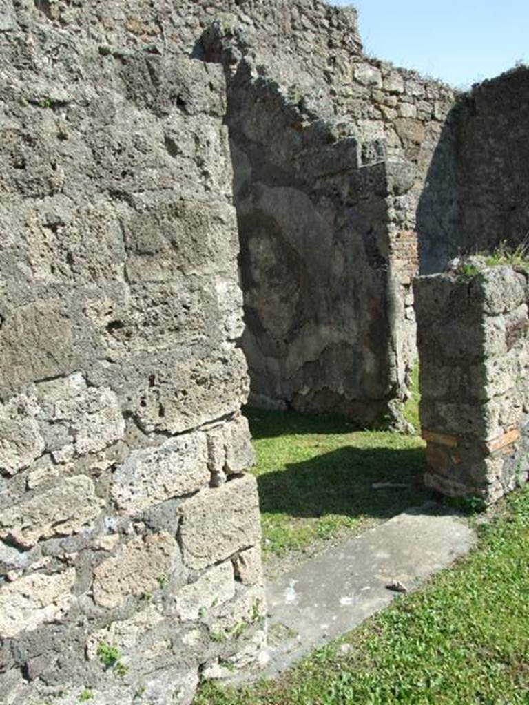 VII.4.57. Pompeii.  March 2009.  Doorway to Room 5, with small doorway to Room 6 in South wall.