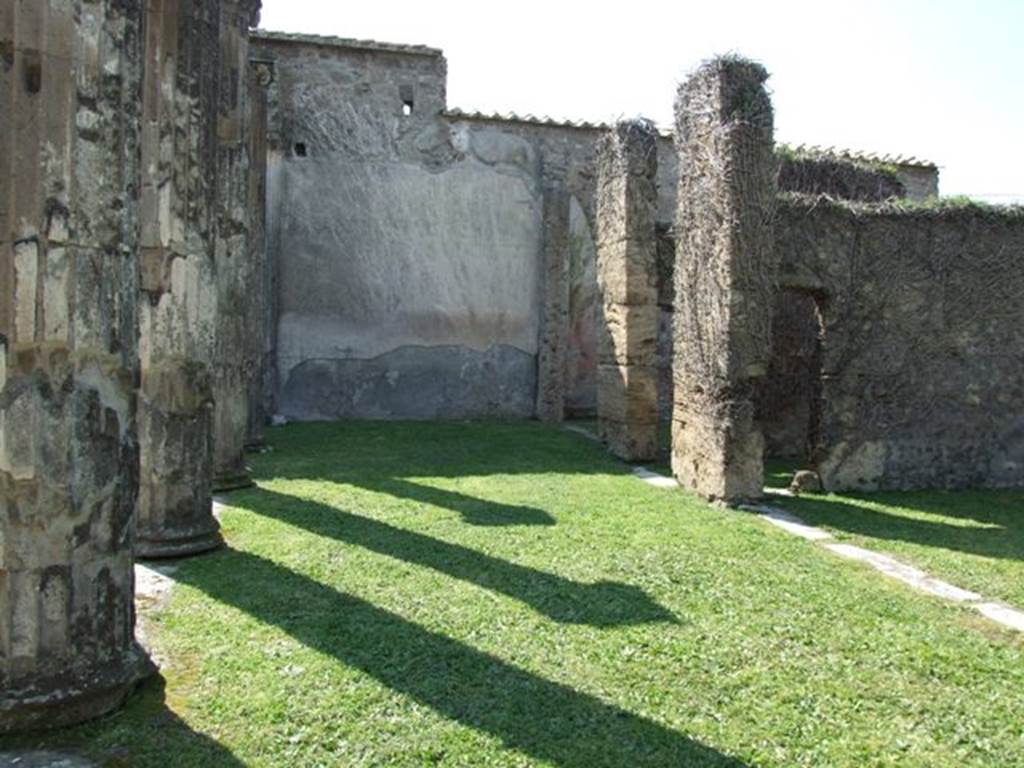 VII.4.57 Pompeii. March 2009. Looking west across north portico, with doorway to tablinum, on right.