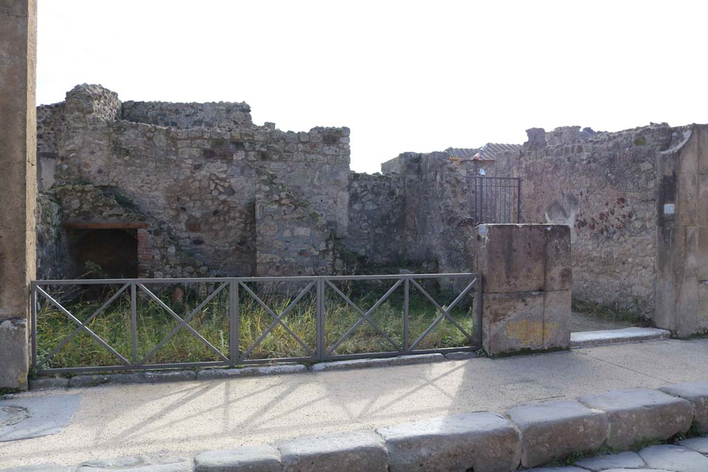 VII.4.58 Pompeii. December 2018. Looking south towards rear wall with two staircases. Photo courtesy of Aude Durand.
According to Avellino
“Si entra in questa per la maggiore delle additate aperture, la cui soglia era di marmo………
Il pavimento è di mattoni pesti: e rosso è l’intonaco.
Sul lato di fronte di questa bottega trovansi diversi gradini di una doppia scaletta di fabbrica. La prima di esse piega a sinistra, comincia dal livello del suolo, e se ne conservano nove scalini che lasciano sotto di essi una cavita. L’altra che segue piega pure a sinistra e dopo tre scalini ha un riposo, dal quale di fronte si ha il passaggio e la discesa nell’atrio, ed incomincia pur la scala a piegare a sinistra essendone conservati sette scalini. E quindi evidente che questa due scalette conducevano a diversi siti: e la loro disposizione ne fa sospettare che la prima conducesse ad una qualche divisione che diremmo ammezzato (contignatio, tabulatum) e la seconda al piano superiore dell’edificio.
Nel corpo del muro esterno di questa bottega, e propriamente nell’angolo che fa colla casa che le e a sinistra, veggonsi i tubi di creta che congiunti tra loro formano il condotto di un cesso o luogo immondo, la cui apertura era situata nel piano superiore.”
(“One enters into this shop by the largest of the openings, whose threshold was of marble..…….
The floor was of mattoni pesti (brick paste): and the plaster was red.
On the opposite side of this shop several steps of a double masonry staircase were found. The first of them leads to the left, starting at ground level, and there are nine steps that leave a recess/opening below them. The other that follows also leads to the left and after three steps has a landing/rest, from which facing you, you have the passage and descent into the atrium, and begins the staircase leading to the left with seven steps being preserved. It is therefore evident that these two staircases led to different sites: and their arrangement makes us suspect that the first led to an area that we would call “mezzanine” (rafters, flooring) and the second to the upper floor of the building.
In the body of the outer wall, and really in the corner of this shop, and properly in the corner that is part of the house that it is on the left of, we see the clay pipes that joined together to form the conduit of a toilet or unclean place, whose opening was located in the upper floor.”)
See Avellino, F.M. Descrizione di una casa disotterrata in Pompei negli anni 1832, 1833 e 1834, la seconda alle spalle del tempio di Fortuna Augusta. (p.5-8)