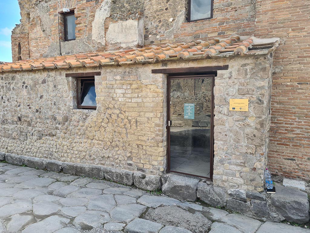 VII.5.8 Pompeii. October 2024. Looking south across Via delle Terme towards entrance doorway. Photo courtesy of Klaus Heese.