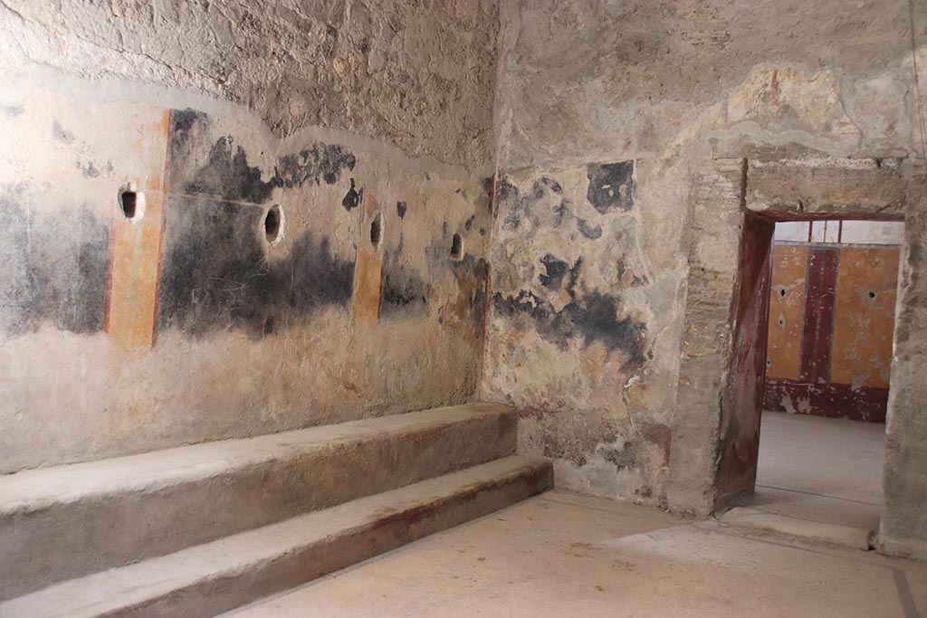 VII.5.8 Pompeii. October 2024.
Room 46, looking south along east wall towards doorway to Tepidarium 49, on right. Photo courtesy of Klaus Heese.