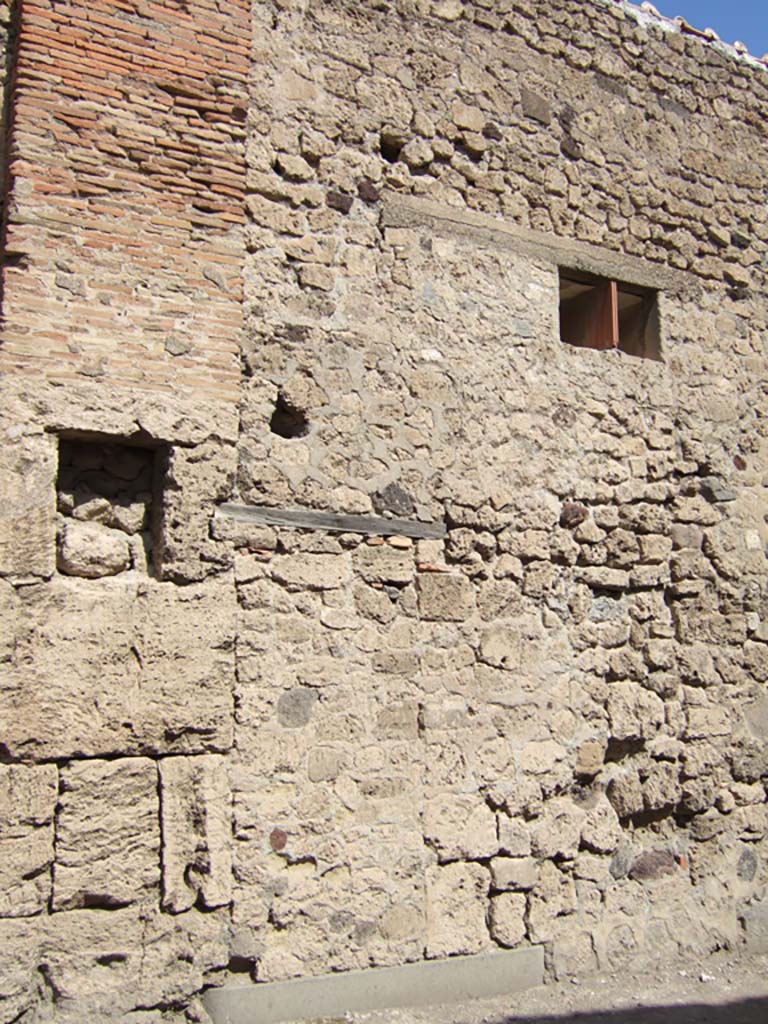 VII.5.16 Pompeii. September 2005. Site of entrance doorway.
According to Garcia y Garcia, all of the south-west corner and southern part of the insula were transformed in the time of Maiuri.
Then the area was hit during the first bombing incursion during the early evening (17.00hrs) of 13th September 1943.
All of the old structures that remained have been modified again to provide a restaurant, toilets and sales area.
The modifications included closing and bricking up of the old doorways to VII.5.14, 15, 16 and 17.
Entrances at VII.5.18, 19 and 20 now provide the doorways to the modern restaurant.
See Garcia y Garcia, L., 2006. Danni di guerra a Pompei. Rome: L’Erma di Bretschneider. (p.101-3).