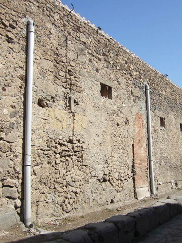 VII.5.17 Pompeii. September 2005. Looking north-east towards site of entrance doorway. According to Garcia y Garcia, all of the south-west corner and southern part of the insula were transformed in the time of Maiuri. Then the area was hit during the first bombing incursion during the early evening (17.00hrs) of 13th September 1943. All of the old structures that remained have been modified again to provide a restaurant, toilets and sales area. The modifications included closing and bricking up of the old doorways to VII.5.14, 15, 16 and 17. Entrances at VII.5.18, 19 and 20 now provide the doorways to the modern restaurant.
See Garcia y Garcia, L., 2006. Danni di guerra a Pompei. Rome: L’Erma di Bretschneider. (p.101-3).