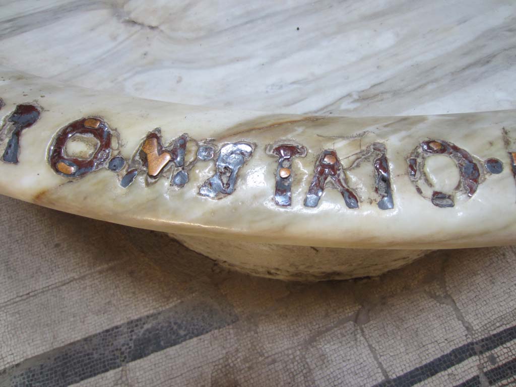 VII.5.24 Pompeii. March 2012.
Remains of bronze lettering (RO. M. STAIO.) from large marble basin or labrum (41) in apse of caldarium (39). Photo courtesy of Marina Fuxa.