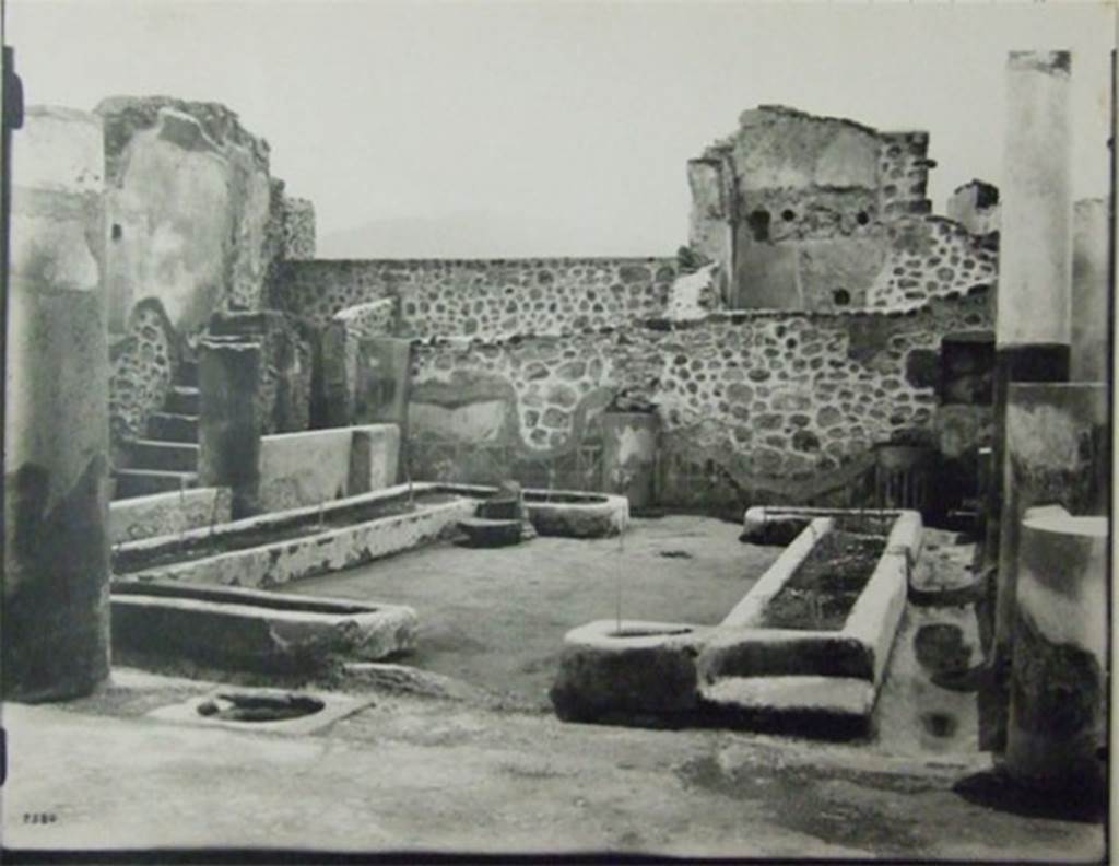 VII.6.7 Pompeii. About 1910. Peristyle garden.
Looking south from north-west corner across two U-shaped masonry flower beds formed by low walls (0.26m. high), originally painted red and filled with soil.
According to Jashemski, the garden at the rear of the tablinum was enclosed on the east, north and west by a portico supported by 7 columns, red below and white above. All lacked capitals at the time of excavation. The rear (south) wall was divided into panels by engaged columns, similar to the columns of the portico. The columns were connected by a low wall, except for a wide entrance to the garden opposite the tablinum: the wall was lower in front of the large room (51) on the east (Jashemski’s plan numbered this room as (b). The panels appear to have been painted with garden paintings. A water channel outlined the garden. There was a cistern opening near the middle column on the north side. Spano found root cavities in the soil of the U-shaped masonry flower beds, but they were not emptied of lapilli, measured or studied. Twenty-eight cavities are indicated on his plan. In the south wall, near the south-east (?) corner of the peristyle was a square niche.
On page 362, no.76, Jashemski wrote – at the time of excavation only the lower part of the rear (south) wall of the garden at the back of the house still had plaster, this was painted to represent a wooden fence (see also Jashemski, vol.1: fig.44 on page 30) which led Spano to believe that there had been a garden painting above. Nothing remains today, for this house was destroyed in 1943.
See Jashemski, W. F., 1993. The Gardens of Pompeii, Volume II: Appendices. New York: Caratzas. (p.184) and (362, no.76).
Her sources included – Spano, Notizie degli Scavi, (1910) pp. 456-457; Boyce G. K., 1937. Corpus of the Lararia of Pompeii. (p. 67 no. 289)
The area was devastated in the 1943 bombing.
The staircase on the east side is the only part still visible in situ.
At the rear of the staircase can be seen two small rooms, the latrine and the kitchen.
According to Boyce: the square niche on the south wall of the peristyle, near the south-west (?) corner, was coated with successive layers of stucco in red green and yellow.
See Boyce G. K., 1937. Corpus of the Lararia of Pompeii. Rome: MAAR 14. (p.67. no.289).
Photograph courtesy of Soprintendenza Speciale per i Beni Archeologici di Napoli e Pompei. (Negative C359)