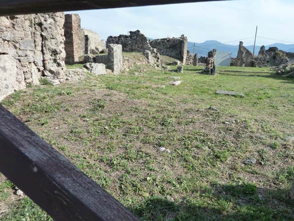 VII.6.8 Pompeii. September 2015. In the foreground behind the wooden gate, would have been the site of the shop at VII.6.8. In the background behind the shop would have been the house at VII.6.7.
