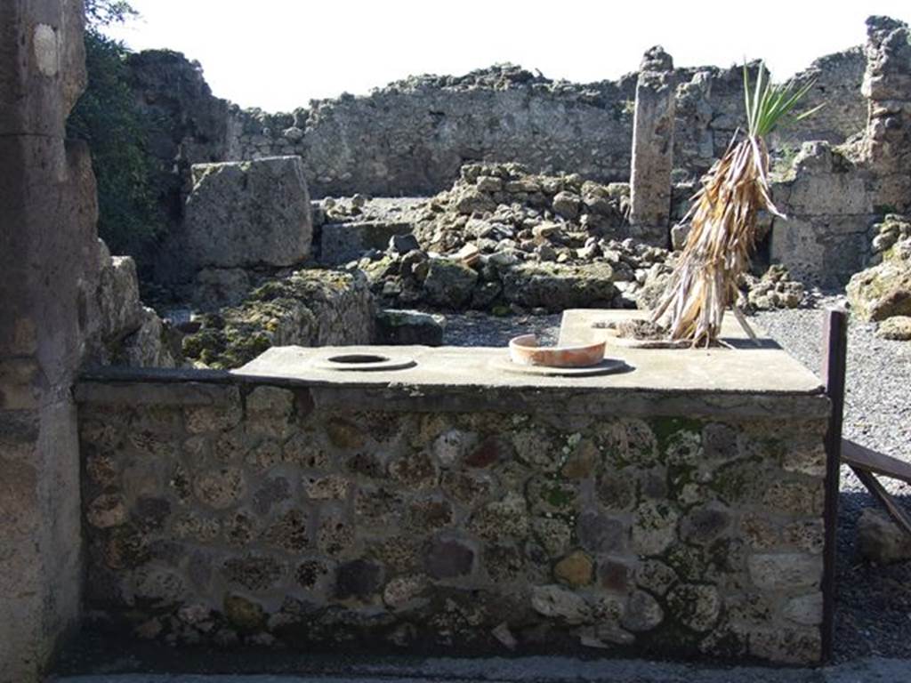 VII.6.20 Pompeii. March 2009. Two sided counter with 3 urns and a hearth.