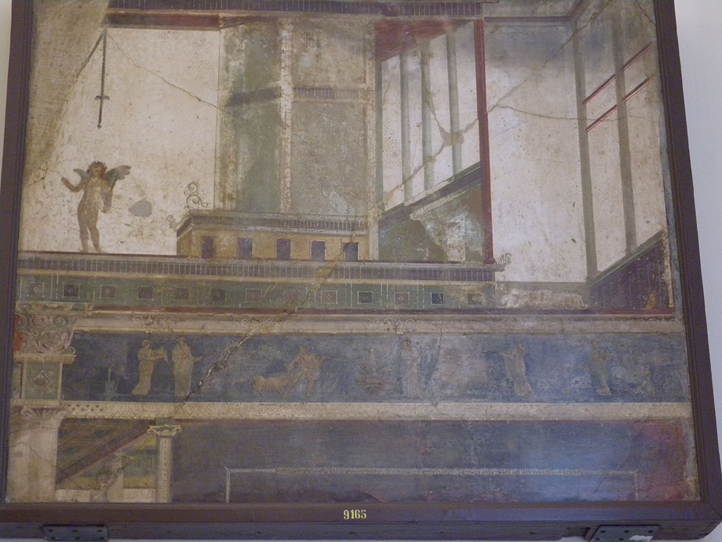 VII.6.28 Pompeii. Found on 10th April 1762. Architectural painting representing 5 doors, columns, capitals, bands and cornices of architecture; above a band is a naked cupid with a stick in the left and an object in the right; bottom scenes of sacrifice.
Now in Naples Archaeological Museum. Inventory number 9165.
See Antichit� di Ercolano: Tomo Quarto: Le Pitture 4, 1765, 45-46, 221-227.
See Helbig, W., 1868. Wandgem�lde der vom Vesuv versch�tteten St�dte Campaniens. Leipzig: Breitkopf und H�rtel, (569).
