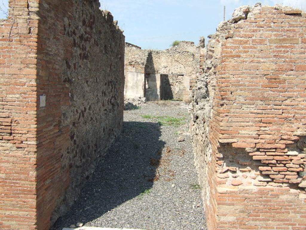 VII.6.30 Pompeii. September 2005. Looking north from entrance doorway. According to Spano in NdS, a staircase made of masonry and lava-stone would have been on the right shortly after the entrance doorway. Also on the right was a small latrine. See Spano in Notizie degli Scavi, 1910, p.481.
By 1873 only the entrance and fauces or entrance corridor had been excavated, according to Fiorelli. See Pappalardo, U., 2001. La Descrizione di Pompei per Giuseppe Fiorelli (1875). Napoli: Massa Editore. (p.160)
According to Della Corte, he surmised that Petutio Quintioni would have been the dweller in this house, judging by an amphora found in the atrium. This amphora was addressed to Petutio Quintioni, and had been sent from Pompeius Onesimus. See Della Corte, M., 1965. Case ed Abitanti di Pompei. Napoli: Fausto Fiorentino. (p.172)