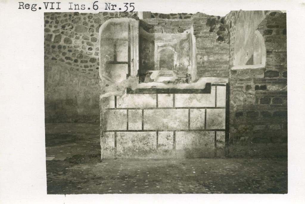 Mystery photo – Warsher numbered this as being from VII.6.35. We hope it is from -
VII.6.30 Pompeii. Pre-1937-39. Looking towards east wall of atrium, room 133/33, with room 139/39 on left.
Photo courtesy of American Academy in Rome, Photographic Archive. Warsher collection no. 560.
According to Boyce, in the east wall of the main room which was entered directly from the fauces was a delicately painted tall, rectangular niche.
He thought this was a Lararium. The white background of the surrounding wall was divided by dark stripes into a series of rectangles.
These rectangles were in imitation of a veneer of slabs of marble or of a wall built of rectangular blocks of stones.
See Boyce G. K., 1937. Corpus of the Lararia of Pompeii. Rome: MAAR 14. (p.67, no.292)
According to the Notizie degli Scavi, 1910, page 481, in the east wall, to the right of the entrance doorway into room numbered 139, was a delicately painted niche, which served as a sacrarium.
If anyone can confirm or refute this location, we would be pleased to hear from you.