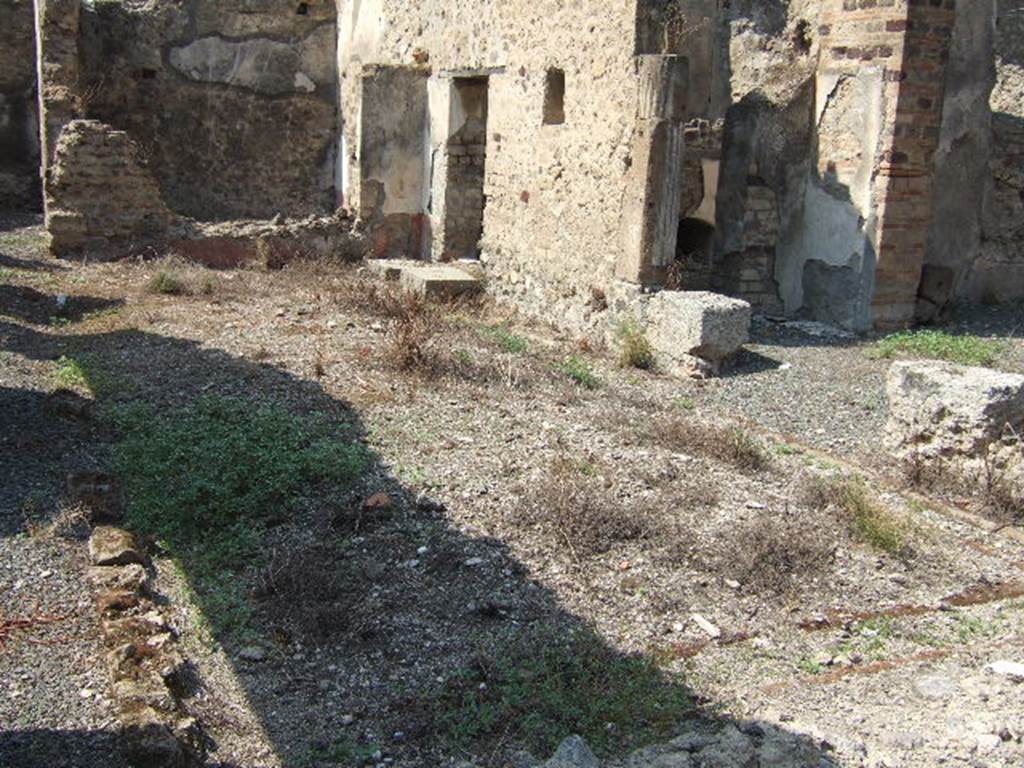 VII.6.30 Pompeii. September 2005. Looking west across garden area.
According to Jashemski, the garden (excavated in 1910) had a roofed passageway on the north, east and south. Only one tufa column was preserved at the time of excavation. A low masonry wall enclosed the garden. The vault of the cistern reached almost to the level of the garden area so it was not possible to plant the central part of the garden. A planting bed was made, however, around the edges of the garden.
See Jashemski, W. F., 1993. The Gardens of Pompeii, Volume II: Appendices. New York: Caratzas. (p.185)