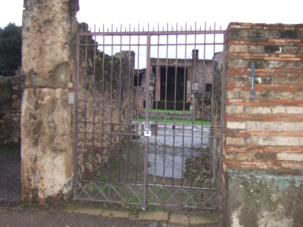 VII.7.5 Pompeii. December 2005. Looking north to entrance doorway into fauces (a). 
Little remains of the floor which consisted of a mixture of lavapesto interspersed with large marble chips.
