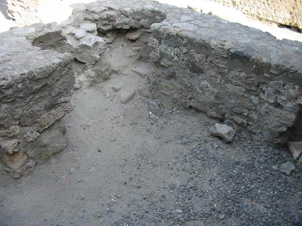 VII.7.9 Pompeii. May 2003. Looking east across rear of two-sided counter, with spaces where there had been two dolia. Photo courtesy of Nicolas Monteix.