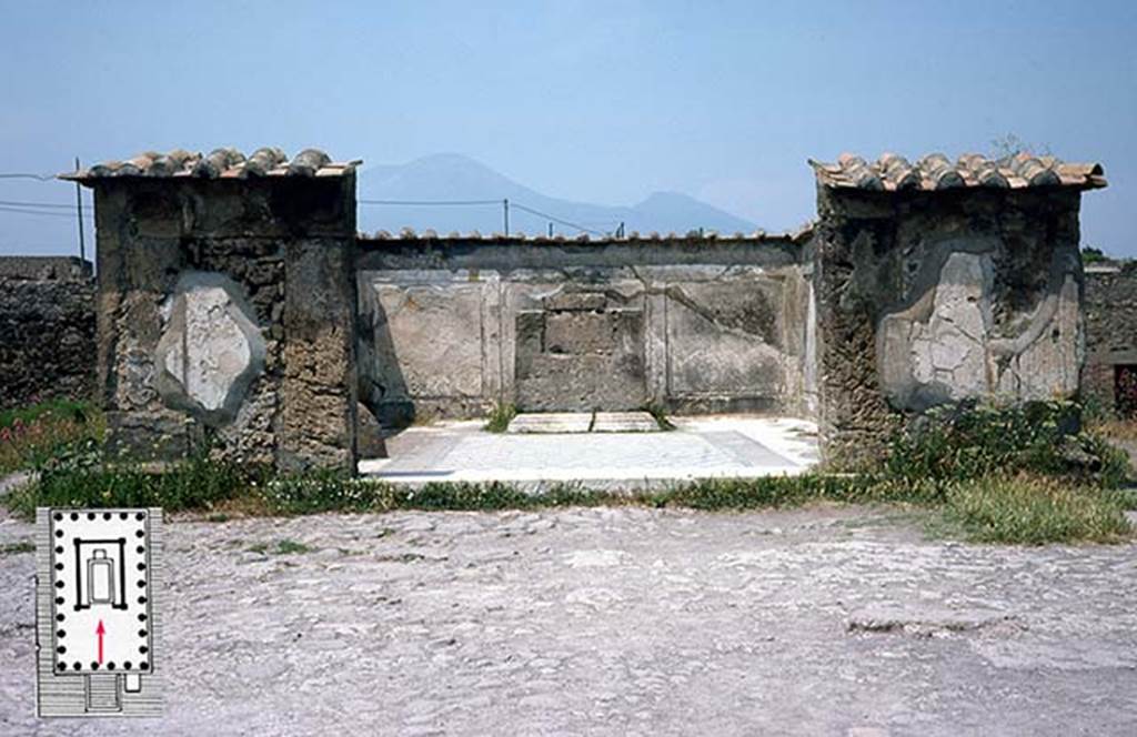 VII.7.32 Pompeii. June 1979 photo of the ruined cella (cult chamber) of the Temple of Apollo, Pompeii. The walls are preserved to only a fraction of their height, and are now protected by modern tiles. The floor was paved with white and black stone in a manner datable to the mid second-century BCE (the early date also indicated by an Oscan inscription that names the quaestor Oppius Campanus, not visible here). Just off to the left, inside the cella wall part of the ovoid stone, or omphalos (the navel) sacred to Apollo is visible. The base for the cult statue survives at the back of the cella (the statue was not found). The stucco covering of the walls is fairly well preserved inside the cella walls, and represents upright orthostats of faux marble . . . an indicator of the so-called First style of Campanian wall decoration (and another indicator of the date of the structure). The door jambs are of Sarno limestone; the cella walls constructed elsewhere of rubble masonry and concrete.
The temple was probably awaiting reconstruction in 70 CE, having been damaged in the earthquake of 62 CE. This photo was taken in 1979 when public access to the temple was permitted. Photo Courtesy of Roger B. Ulrich.