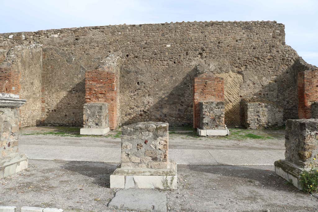 VII.8.00, Pompeii Forum. December 2108.
Looking east towards VII.9.6, on left, VII.9.5 in centre, and altar at VII.9.4, on right, behind statue bases in north-east corner.
Photo courtesy of Aude Durand.