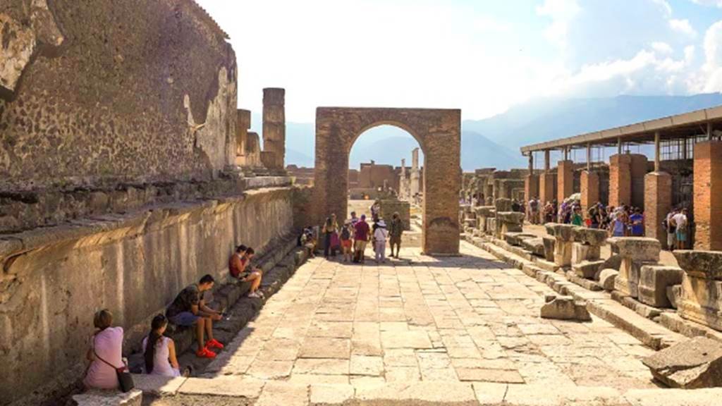 VII.8 Pompeii Forum, August 2021.
Looking south along west side of Forum towards Arch of Augustus, in north-west corner of Forum. Photo courtesy of Robert Hanson.