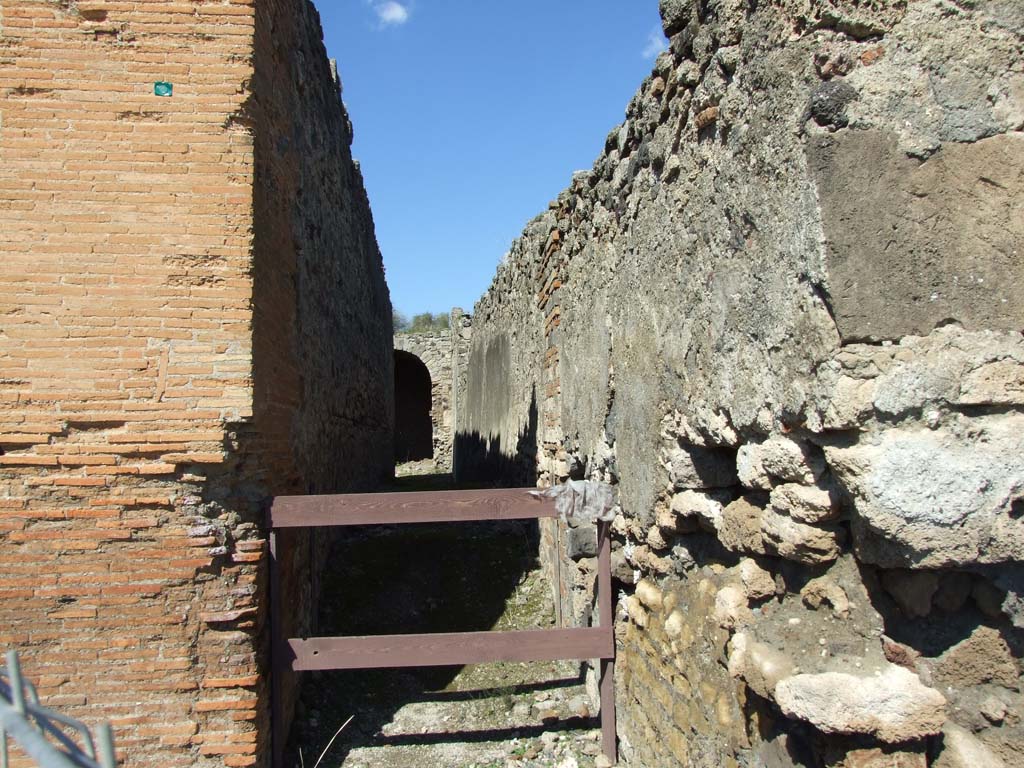 VII.9.1 Pompeii. March 2009. Looking north from north corridor 12 towards VII.9.66.
This entrance is a passage leading along the back of the temples and to VII.9.43.