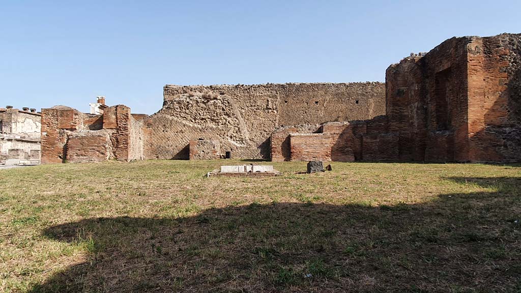 VII.9.3 Pompeii. August 2021. Looking north.
Foto Annette Haug, ERC Grant 681269 DÉCOR.
According to Garcia y Garcia –
“The so-called Chapel of the Public Lares. This was bombed on the same night of September 13th, together with the public buildings which surround it, it suffered the demolition of a large part of the perimeter wall to the north connecting with the Macellum, and the dismantling of part of the brick work of the apse on the north side of the sanctuary.”
See Garcia y Garcia, L., 2006. Danni di guerra a Pompei. Rome: L’Erma di Bretschneider, (p.124)