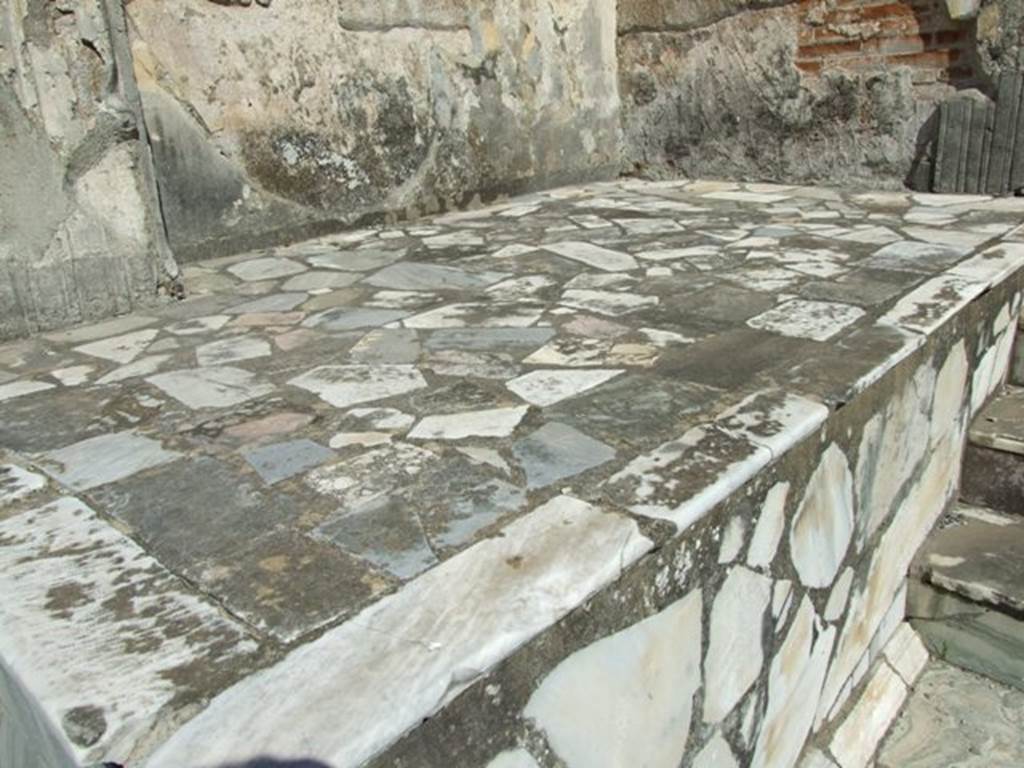 VII.9.7 and VII.9.8 Pompeii. Macellum. March 2009. Marble podium on north side of steps.