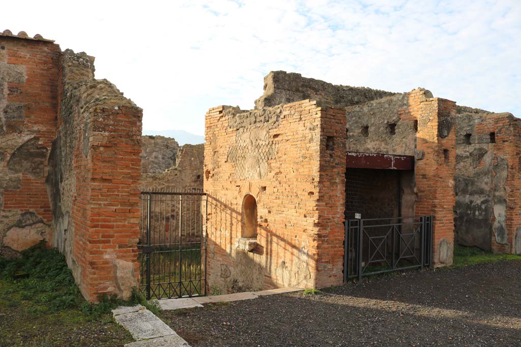 VII.9.7 and VII.9.8 Pompeii. Macellum. December 2018.
Looking towards south entrance of Macellum, with altar, looking down steps to Vicolo del Balcone Pensile, at VII.9.42.
Photo courtesy of Aude Durand.